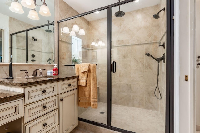 161 Jackson St, Columbus, OH 43206 - bathroom featuring a chandelier, vanity, and a shower stall