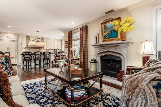 161 Jackson St, Columbus, OH 43206 - living area featuring dark wood-style flooring, a fireplace, recessed lighting, and crown molding