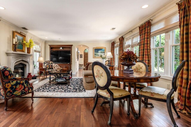 161 Jackson St, Columbus, OH 43206 - dining space featuring arched walkways, hardwood / wood-style flooring, crown molding, a fireplace, and recessed lighting