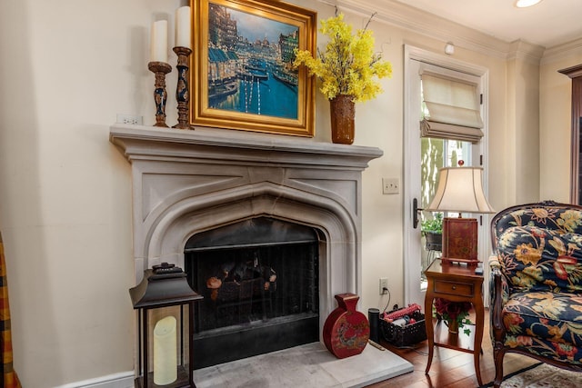 161 Jackson St, Columbus, OH 43206 - detailed view of a fireplace with raised hearth, wood finished floors, and crown molding