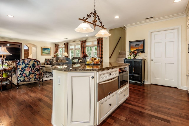 161 Jackson St, Columbus, OH 43206 - kitchen featuring a warming drawer, dark wood-style flooring, open floor plan, crown molding, and a kitchen island
