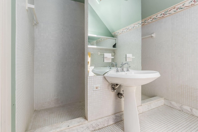 161 Jackson St, Columbus, OH 43206 - bathroom featuring tile patterned floors, tile walls, and vaulted ceiling