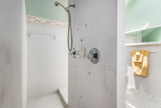 161 Jackson St, Columbus, OH 43206 - full bathroom with tile walls, a tile shower, tile patterned floors, and wainscoting