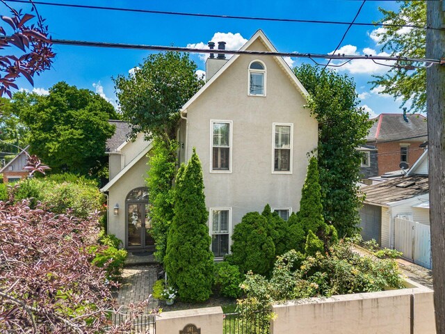 161 Jackson St, Columbus, OH 43206 - view of property exterior with stucco siding, a chimney, and french doors