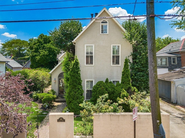 161 Jackson St, Columbus, OH 43206 - view of side of home featuring a fenced front yard and stucco siding