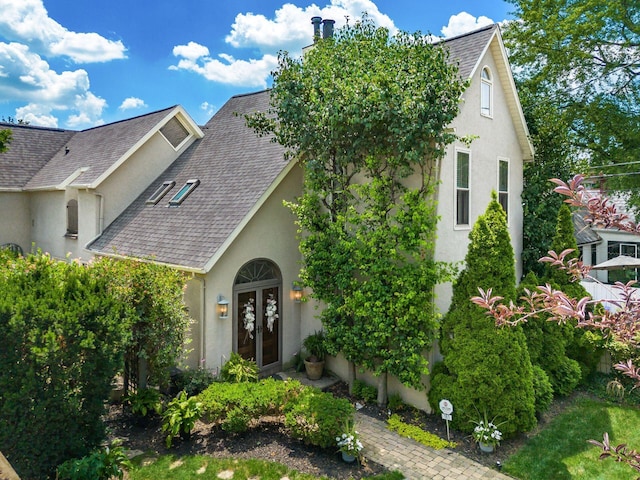 161 Jackson St, Columbus, OH 43206 - view of front of home with french doors, stucco siding, a shingled roof, and a chimney