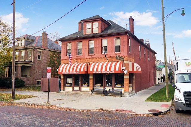 161 Jackson St, Columbus, OH 43206 - view of front of property with a chimney and brick siding