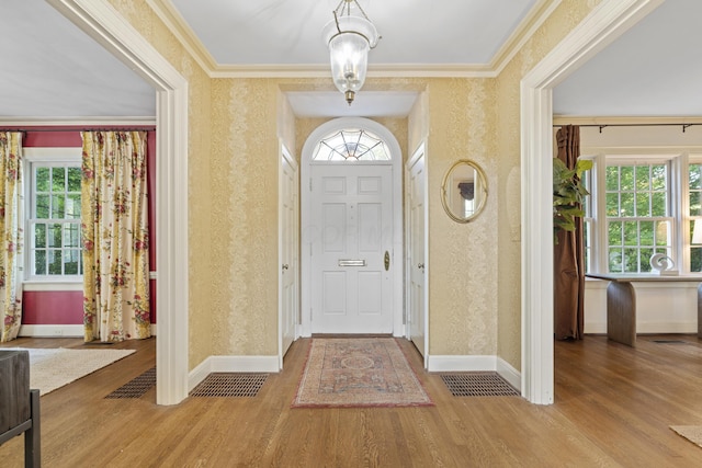 130 Boving Rd, Lancaster, OH 43130 - foyer entrance with wallpapered walls, wood finished floors, healthy amount of natural light, and crown molding