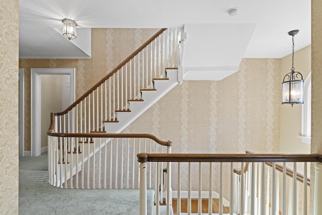 130 Boving Rd, Lancaster, OH 43130 - stairway featuring wallpapered walls, carpet floors, and a chandelier