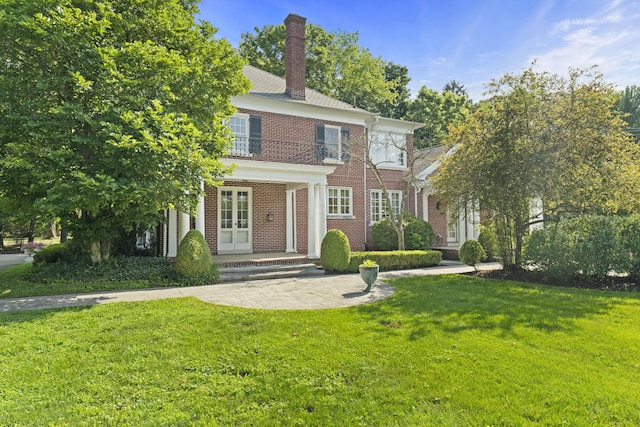130 Boving Rd, Lancaster, OH 43130 - view of front of property featuring french doors, a front yard, brick siding, and a chimney