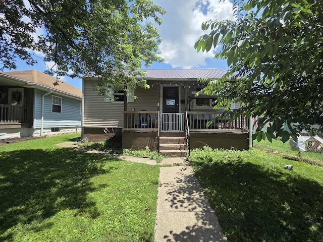 108 N George St, Lancaster, OH 43130 - view of front of home featuring covered porch, a front lawn, and a metal roof