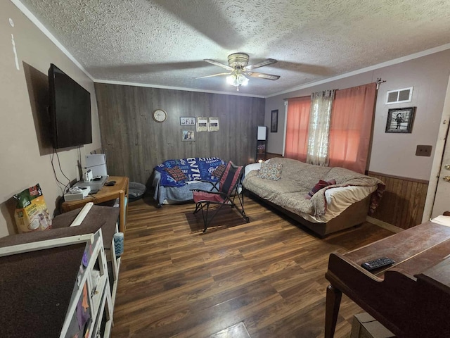 108 N George St, Lancaster, OH 43130 - living room with wood walls, wood finished floors, a ceiling fan, crown molding, and a textured ceiling