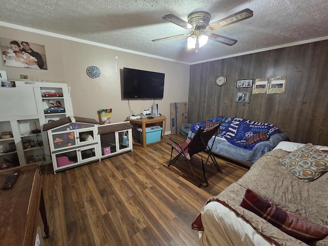 108 N George St, Lancaster, OH 43130 - living area featuring a textured ceiling, wood finished floors, wooden walls, crown molding, and ceiling fan