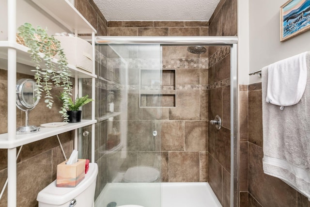 2328 Terrance Dr Unit 76, Columbus, OH 43220 - bathroom featuring a stall shower, a textured ceiling, and tile walls