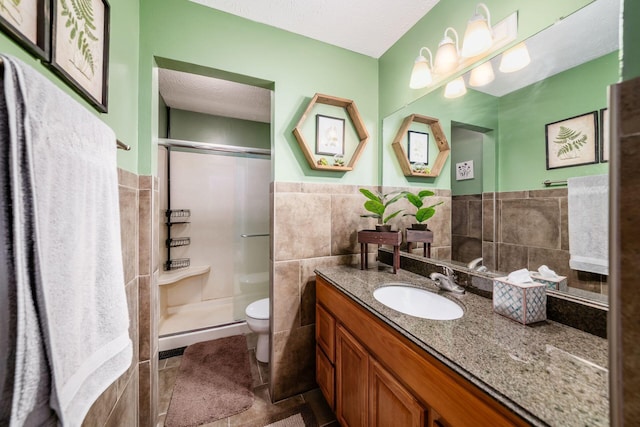 2328 Terrance Dr Unit 76, Columbus, OH 43220 - full bath featuring tile walls, a stall shower, vanity, tile patterned flooring, and a textured ceiling