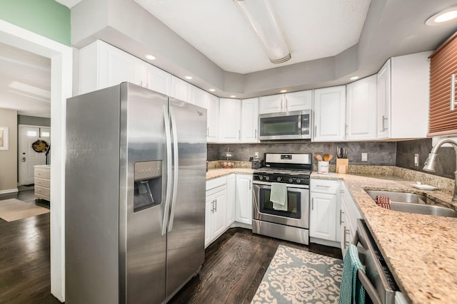 2328 Terrance Dr Unit 76, Columbus, OH 43220 - kitchen featuring stainless steel appliances, tasteful backsplash, dark wood finished floors, white cabinets, and recessed lighting