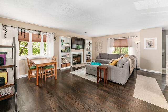2328 Terrance Dr Unit 76, Columbus, OH 43220 - living room featuring plenty of natural light, dark wood-style floors, a textured ceiling, and a fireplace with flush hearth