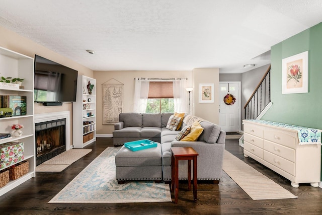 2328 Terrance Dr Unit 76, Columbus, OH 43220 - living area with dark wood-style floors, stairway, a fireplace with flush hearth, and a textured ceiling