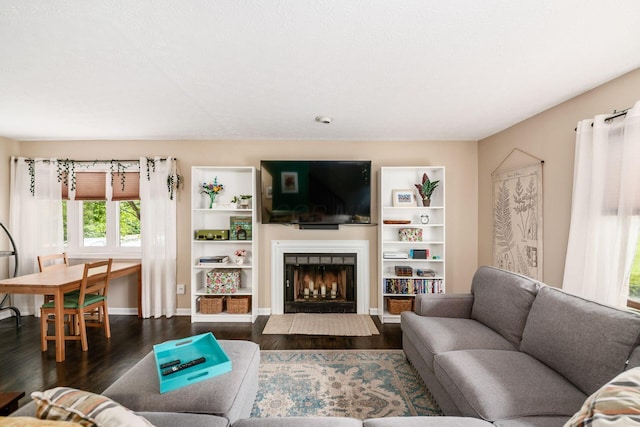 2328 Terrance Dr Unit 76, Columbus, OH 43220 - living room featuring dark wood-type flooring and a fireplace with flush hearth