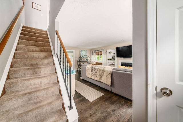 2328 Terrance Dr Unit 76, Columbus, OH 43220 - stairway with wood finished floors and a fireplace