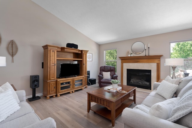 8090 Tree Lake Blvd, Powell, OH 43065 - living room featuring light wood-style flooring, vaulted ceiling, and a glass covered fireplace