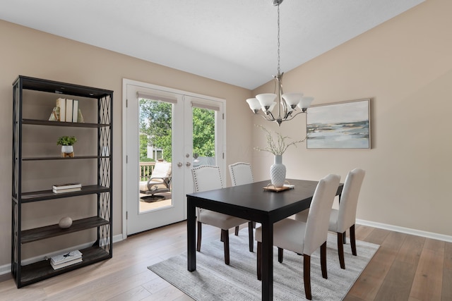 8090 Tree Lake Blvd, Powell, OH 43065 - dining room featuring french doors, a chandelier, light wood finished floors, and lofted ceiling