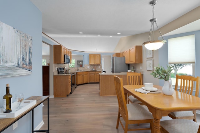 8090 Tree Lake Blvd, Powell, OH 43065 - dining area featuring plenty of natural light, recessed lighting, light wood-style flooring, and vaulted ceiling