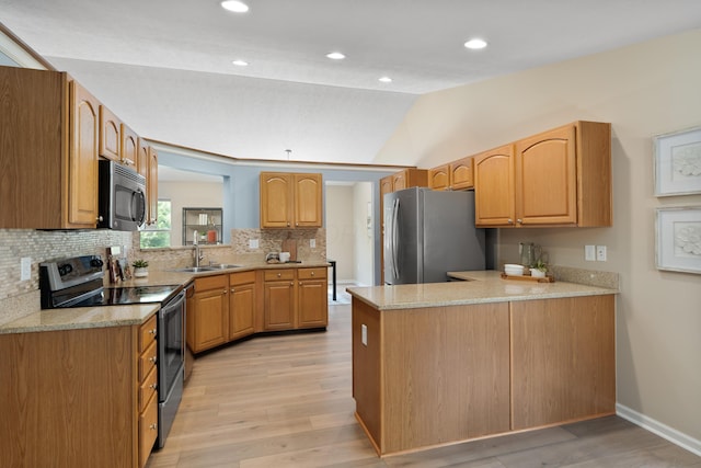 8090 Tree Lake Blvd, Powell, OH 43065 - kitchen with appliances with stainless steel finishes, vaulted ceiling, light wood finished floors, tasteful backsplash, and a peninsula