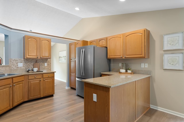 8090 Tree Lake Blvd, Powell, OH 43065 - kitchen with freestanding refrigerator, lofted ceiling, light wood-style flooring, backsplash, and recessed lighting