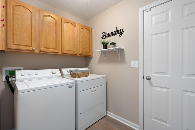 8090 Tree Lake Blvd, Powell, OH 43065 - laundry room with washing machine and clothes dryer, cabinet space, wood finished floors, and a textured ceiling