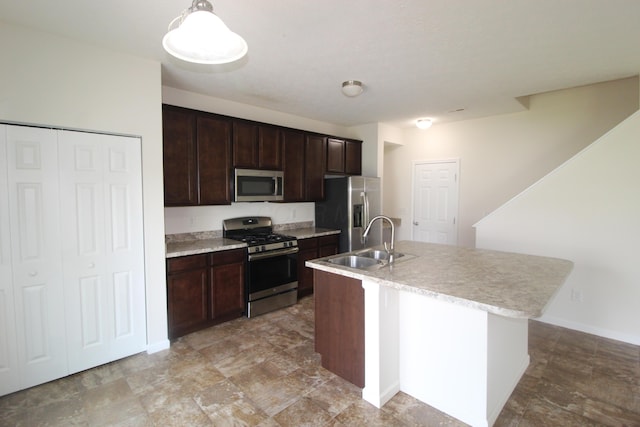 3348 Glasgow Dr, Groveport, OH 43125 - kitchen featuring stainless steel appliances, dark brown cabinetry, a center island with sink, and pendant lighting