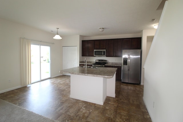 3348 Glasgow Dr, Groveport, OH 43125 - kitchen with stainless steel appliances, dark brown cabinets, an island with sink, light countertops, and hanging light fixtures