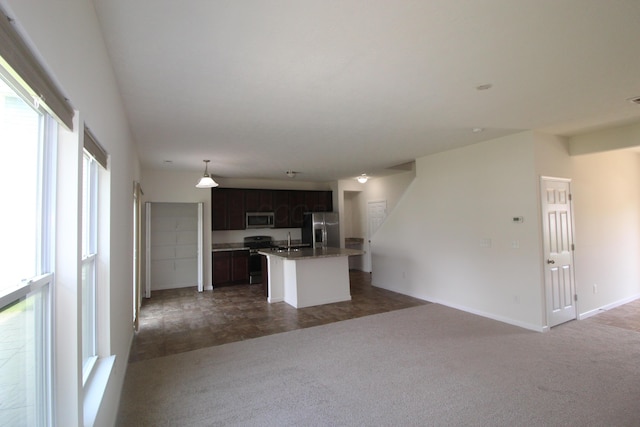3348 Glasgow Dr, Groveport, OH 43125 - kitchen featuring appliances with stainless steel finishes, open floor plan, dark colored carpet, a kitchen island with sink, and pendant lighting