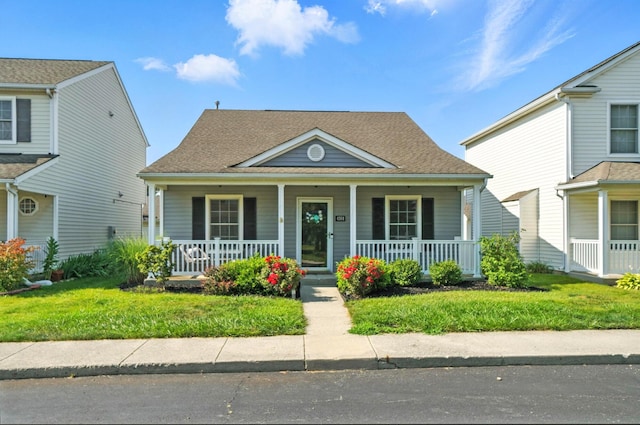 4764 Mattox St Unit 44, Columbus, OH 43228 - view of front facade featuring a porch, a front yard, and roof with shingles
