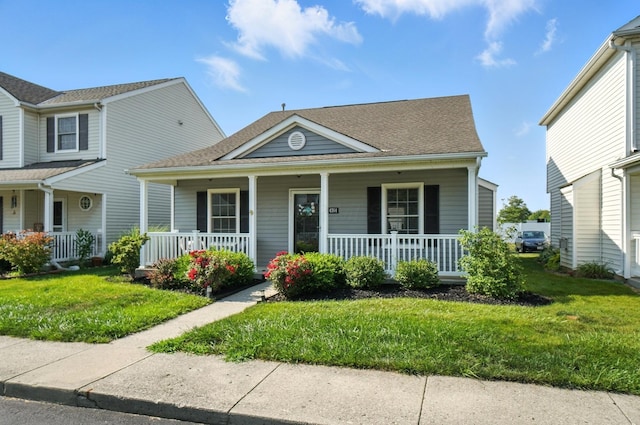 4764 Mattox St Unit 44, Columbus, OH 43228 - view of front of property with covered porch, a front yard, and a shingled roof