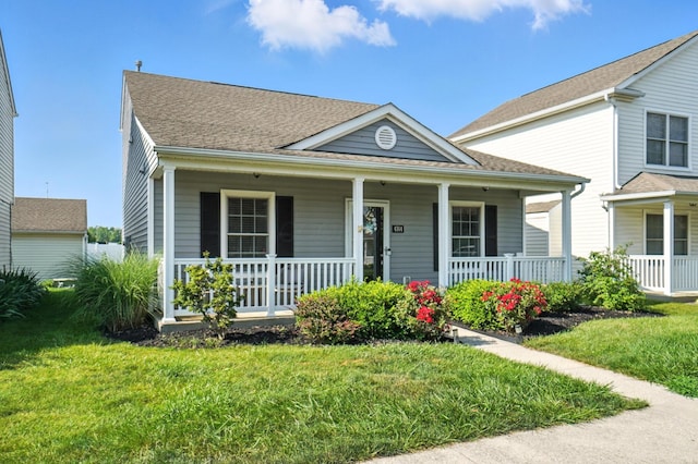 4764 Mattox St Unit 44, Columbus, OH 43228 - view of front of property featuring a porch, a front yard, and roof with shingles