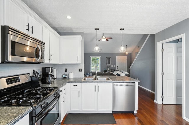4764 Mattox St Unit 44, Columbus, OH 43228 - kitchen with stainless steel appliances, a ceiling fan, dark countertops, white cabinetry, and dark wood-style floors