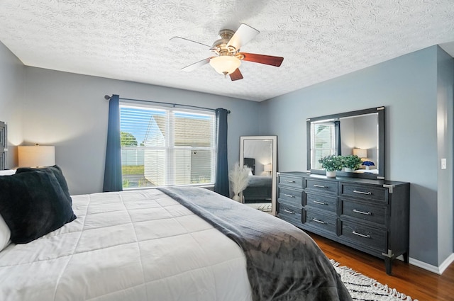 4764 Mattox St Unit 44, Columbus, OH 43228 - bedroom with multiple windows, dark wood-style flooring, a textured ceiling, and ceiling fan