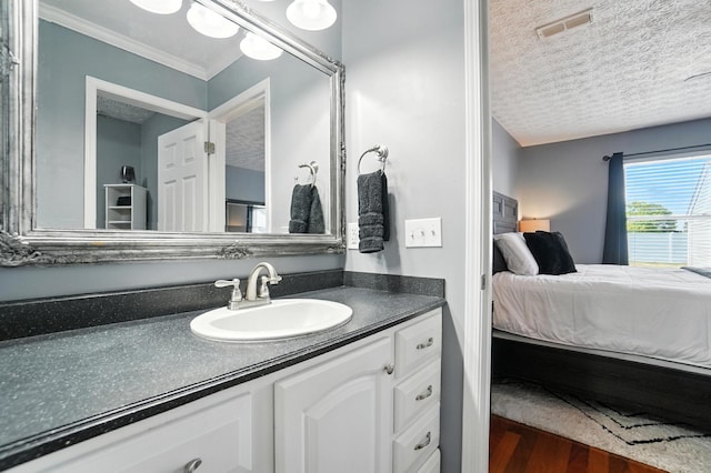 4764 Mattox St Unit 44, Columbus, OH 43228 - bathroom featuring ensuite bathroom, a textured ceiling, vanity, wood finished floors, and ornamental molding