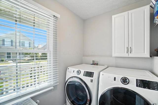 4764 Mattox St Unit 44, Columbus, OH 43228 - laundry room featuring cabinet space, separate washer and dryer, and a textured ceiling