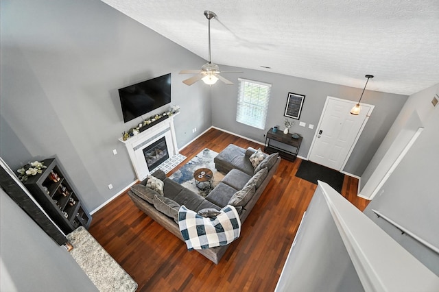 4764 Mattox St Unit 44, Columbus, OH 43228 - living room featuring a textured ceiling, a ceiling fan, vaulted ceiling, a glass covered fireplace, and wood finished floors
