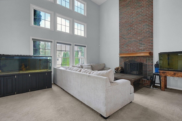 9287 Auburn Ct, Powell, OH 43065 - living area featuring a high ceiling, a brick fireplace, and light colored carpet