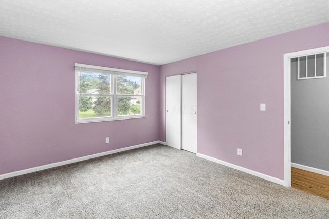 2483 Onyx Ct, Grove City, OH 43123 - unfurnished bedroom with carpet flooring, a textured ceiling, and a closet