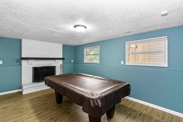 2483 Onyx Ct, Grove City, OH 43123 - game room featuring wood finished floors, billiards table, a fireplace, and a textured ceiling