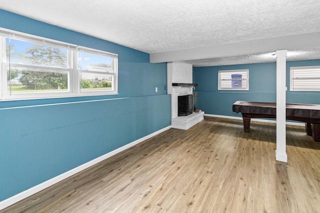 2483 Onyx Ct, Grove City, OH 43123 - playroom featuring a textured ceiling, wood finished floors, a brick fireplace, and billiards