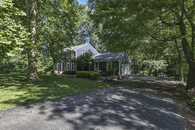 10 Denbigh Dr, Granville, OH 43023 - view of front of property featuring a garage, asphalt driveway, a front lawn, and a storage unit