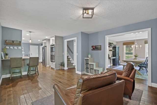 10 Denbigh Dr, Granville, OH 43023 - living room featuring dark wood-style flooring, stairway, a textured ceiling, recessed lighting, and a chandelier