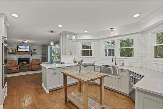 10 Denbigh Dr, Granville, OH 43023 - kitchen with appliances with stainless steel finishes, a fireplace, open floor plan, and decorative backsplash