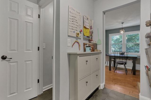 10 Denbigh Dr, Granville, OH 43023 - corridor featuring a chandelier and dark wood finished floors