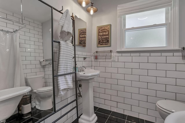10 Denbigh Dr, Granville, OH 43023 - bathroom featuring tile walls, curtained shower, and a wainscoted wall